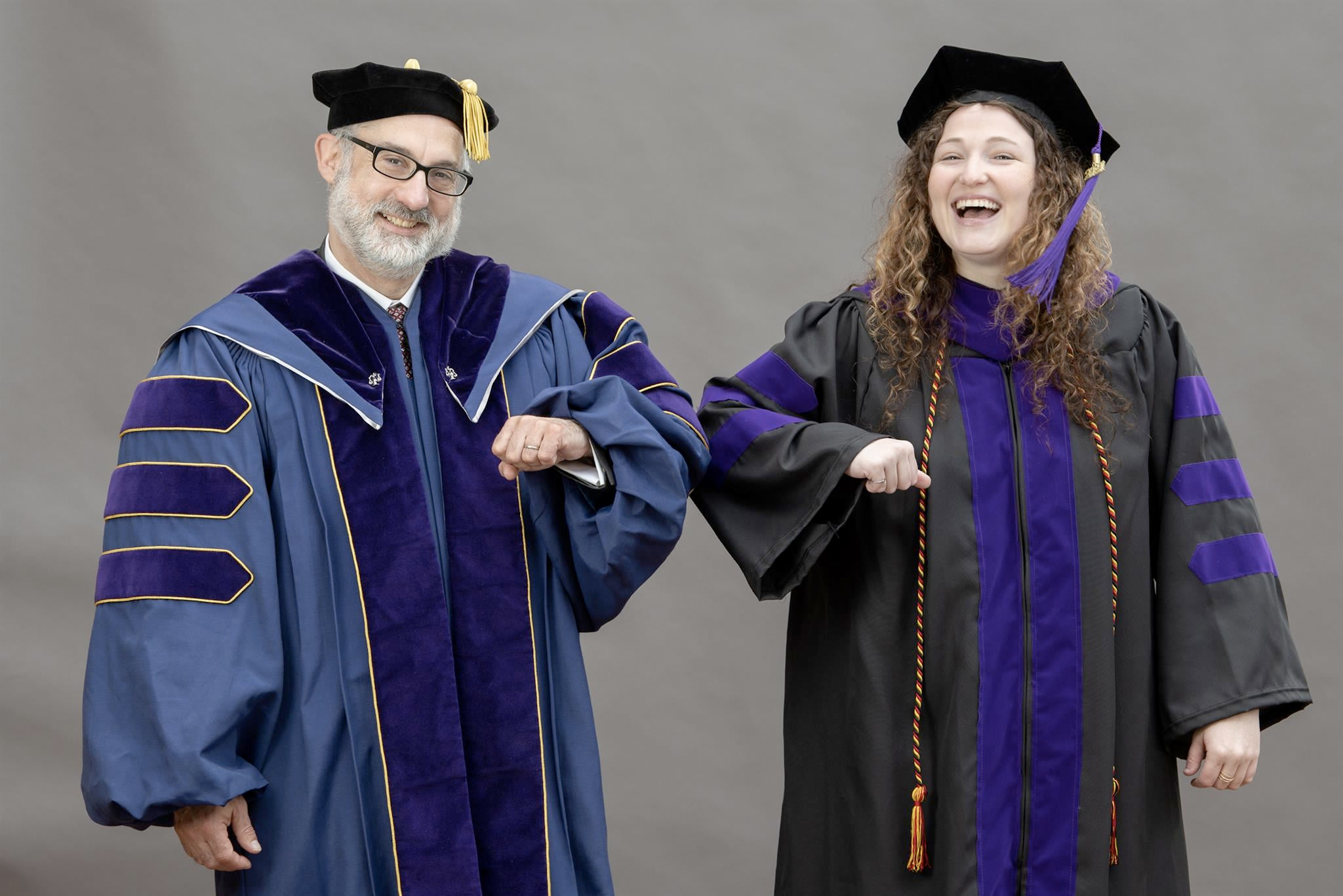 Two School of Law faculty in commencement outfits