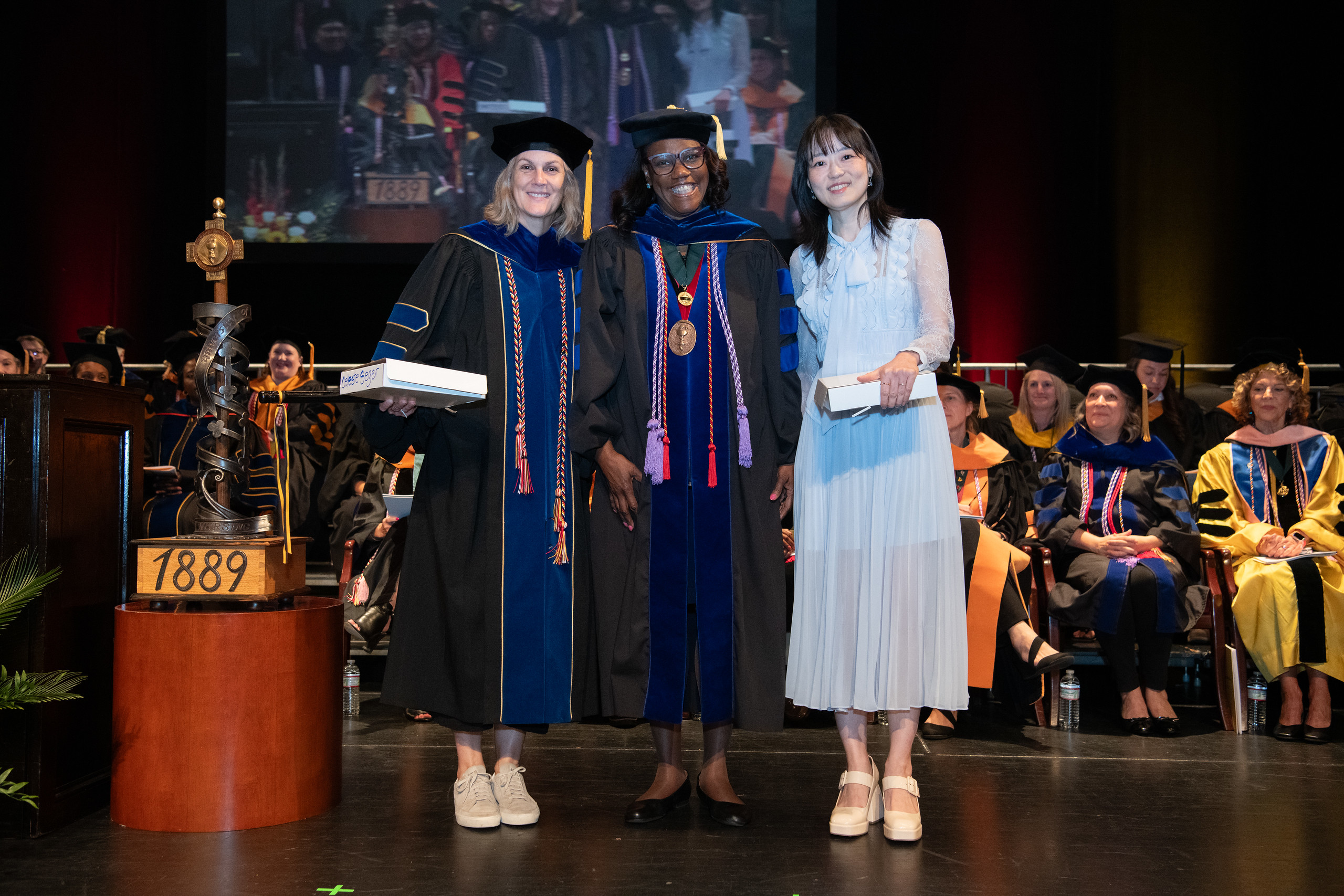 Dean and Staff on Graduation Stage