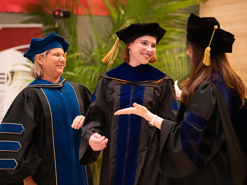 Trio of UMB Graduate Studies graduates conversing