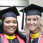 A pair of smiling graduates