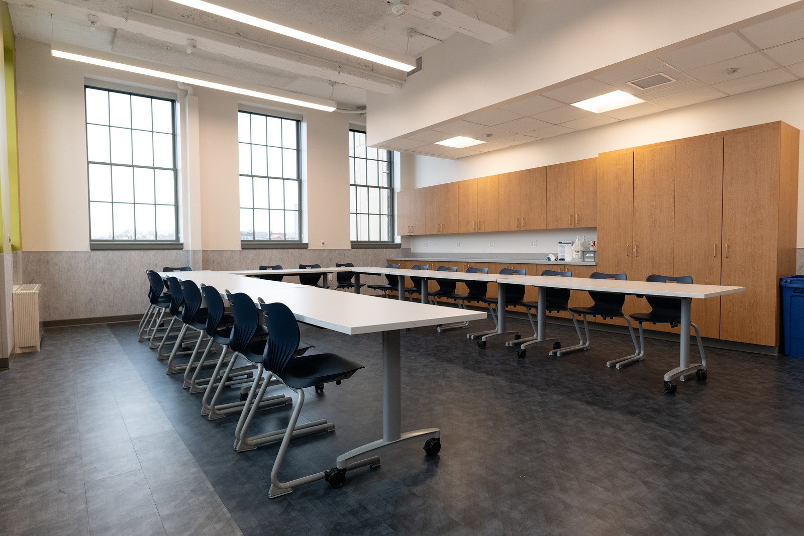 brightly lit classroom with tables and chairs