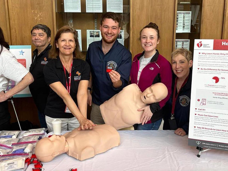 Four adults learn and demonstrate CPR