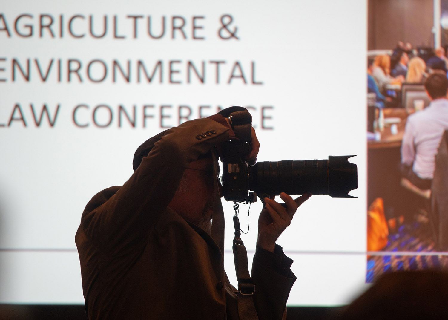 silhouette of a photographer taking a photo at an event