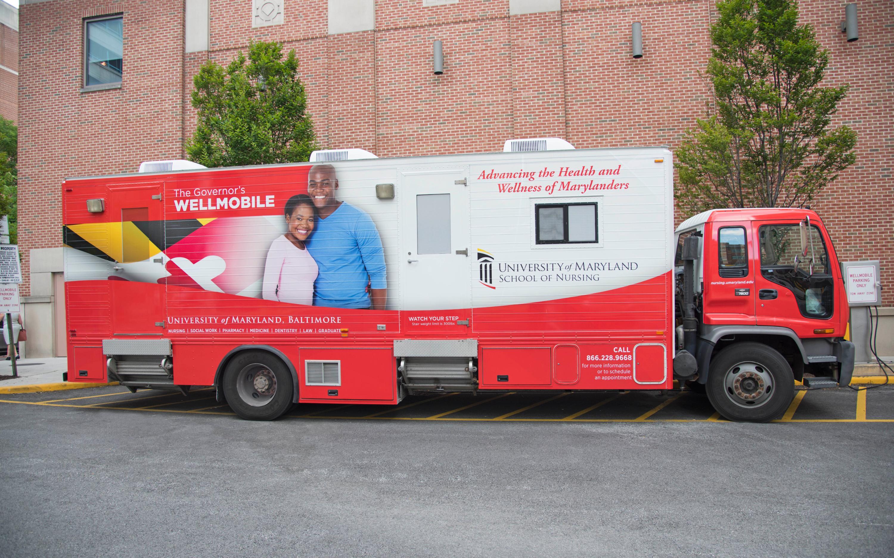 mobile medical vehicle with branded graphics on the side for UMB School of Nursing