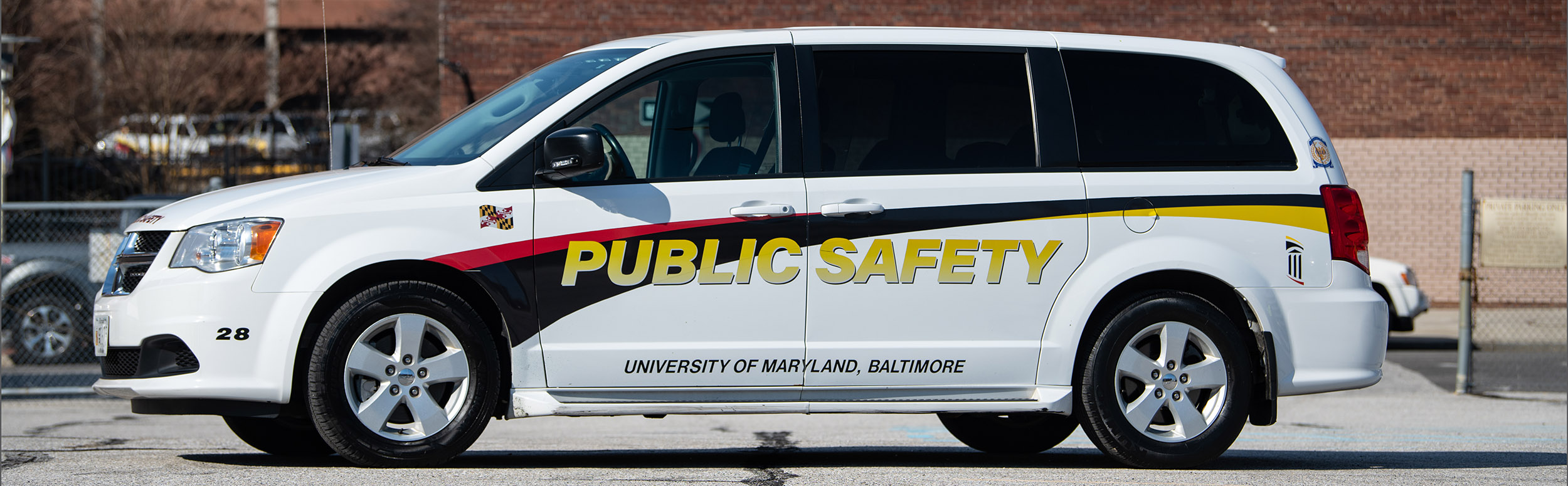 white minivan with UMB Public Safety branded graphics on the side