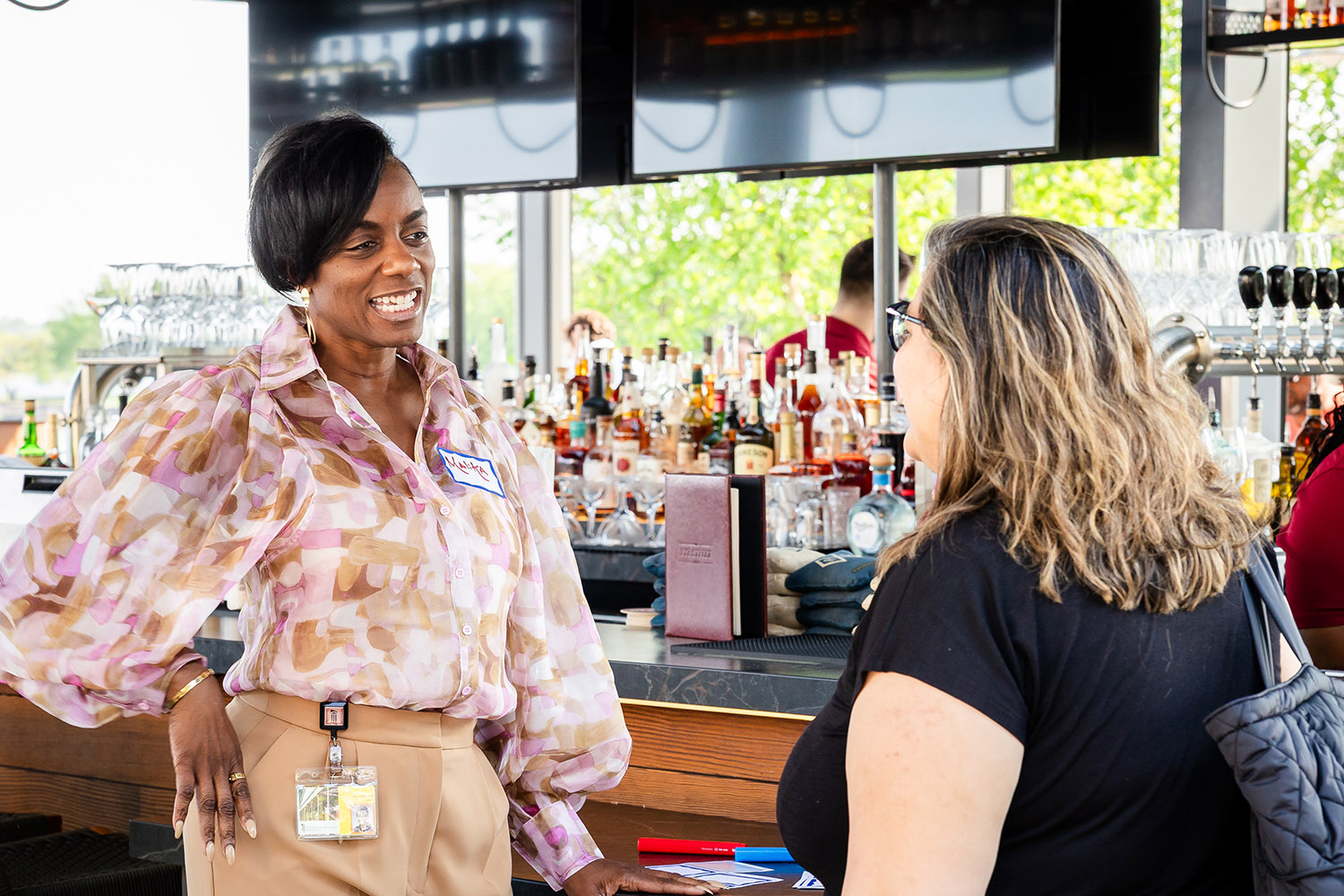 colleagues talk at a networking event