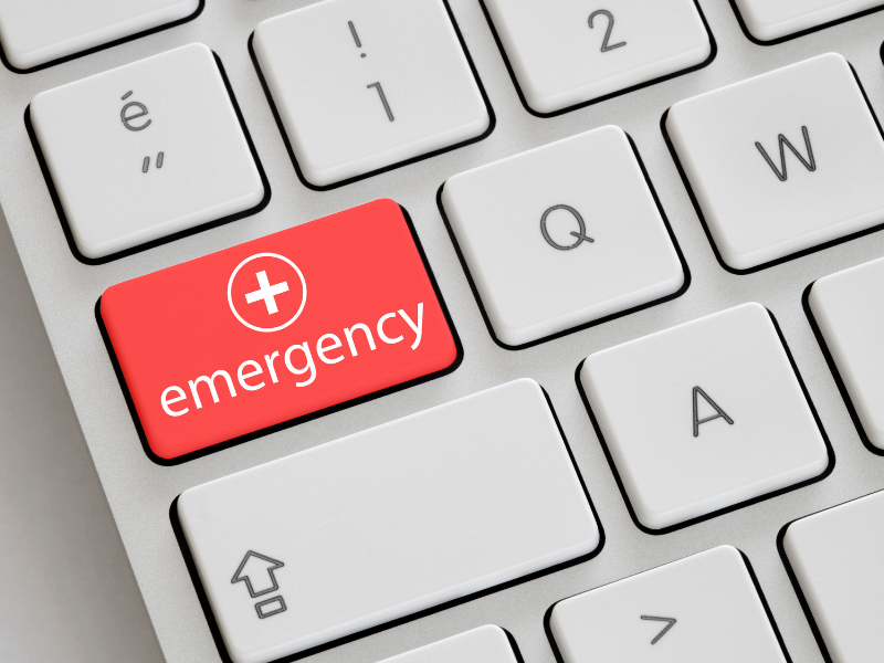 A keyboard with a red Emergency button