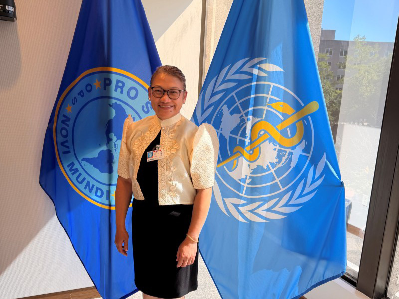 Angelica Fernandez-Dizon in front of WHO flags