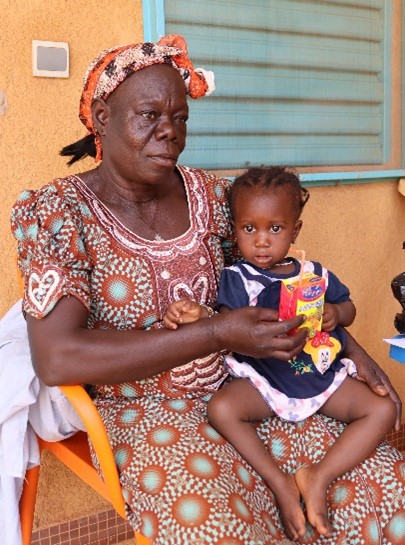 A woman holds a child on her lap