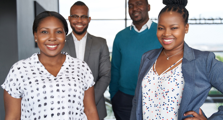 Two black women and two black men pose for a photo