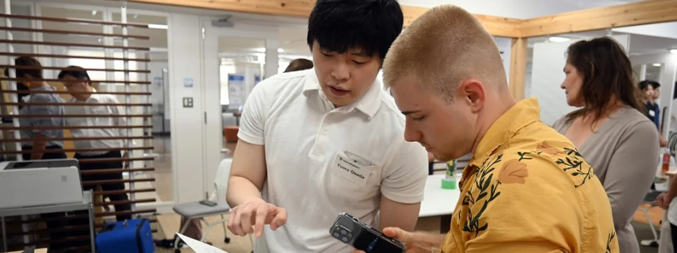A Japanese and UMB student examine medical equipment