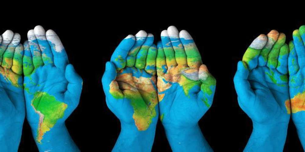 Three sets of hands painted as one large map of the world