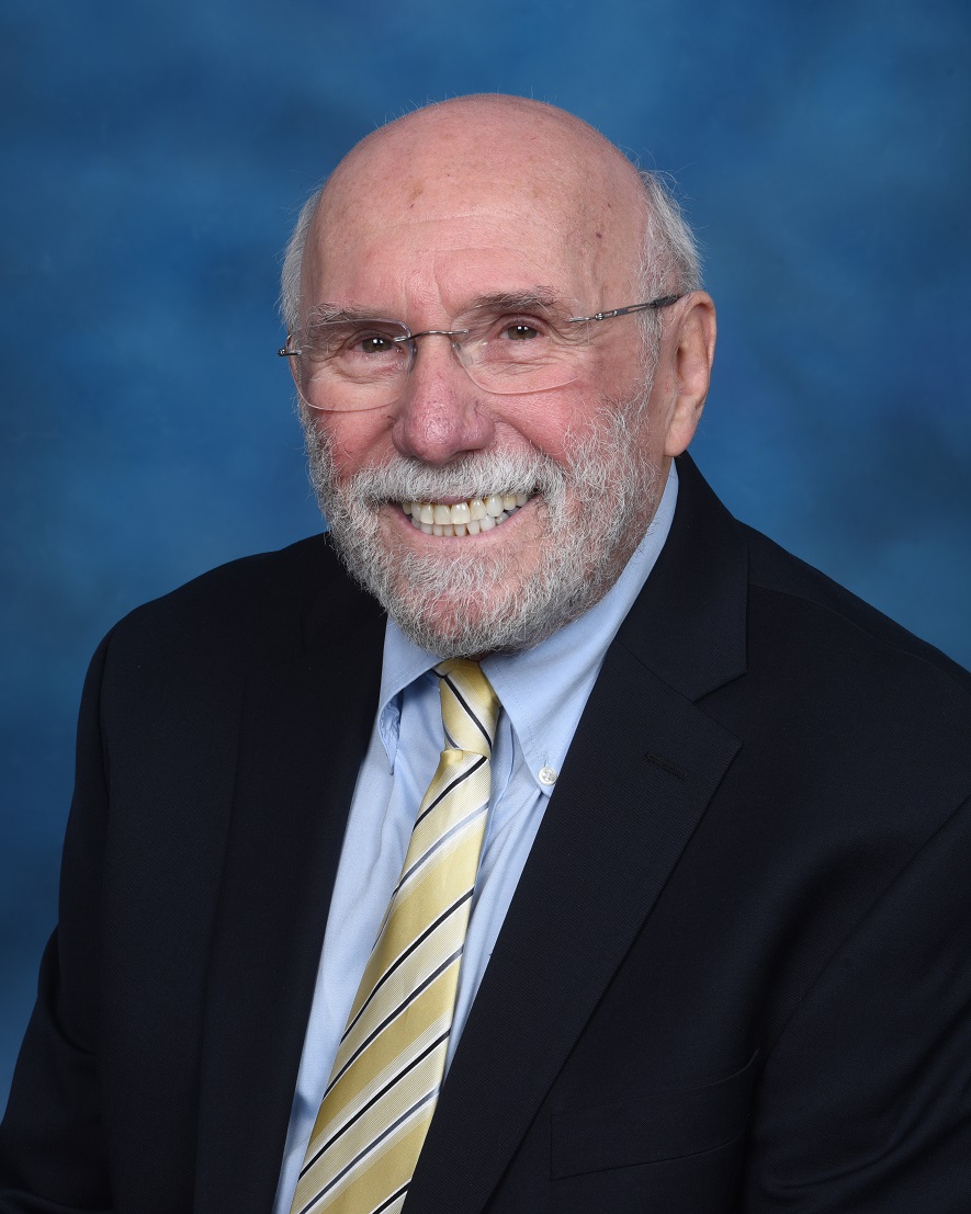 Headshot of a man in a suit