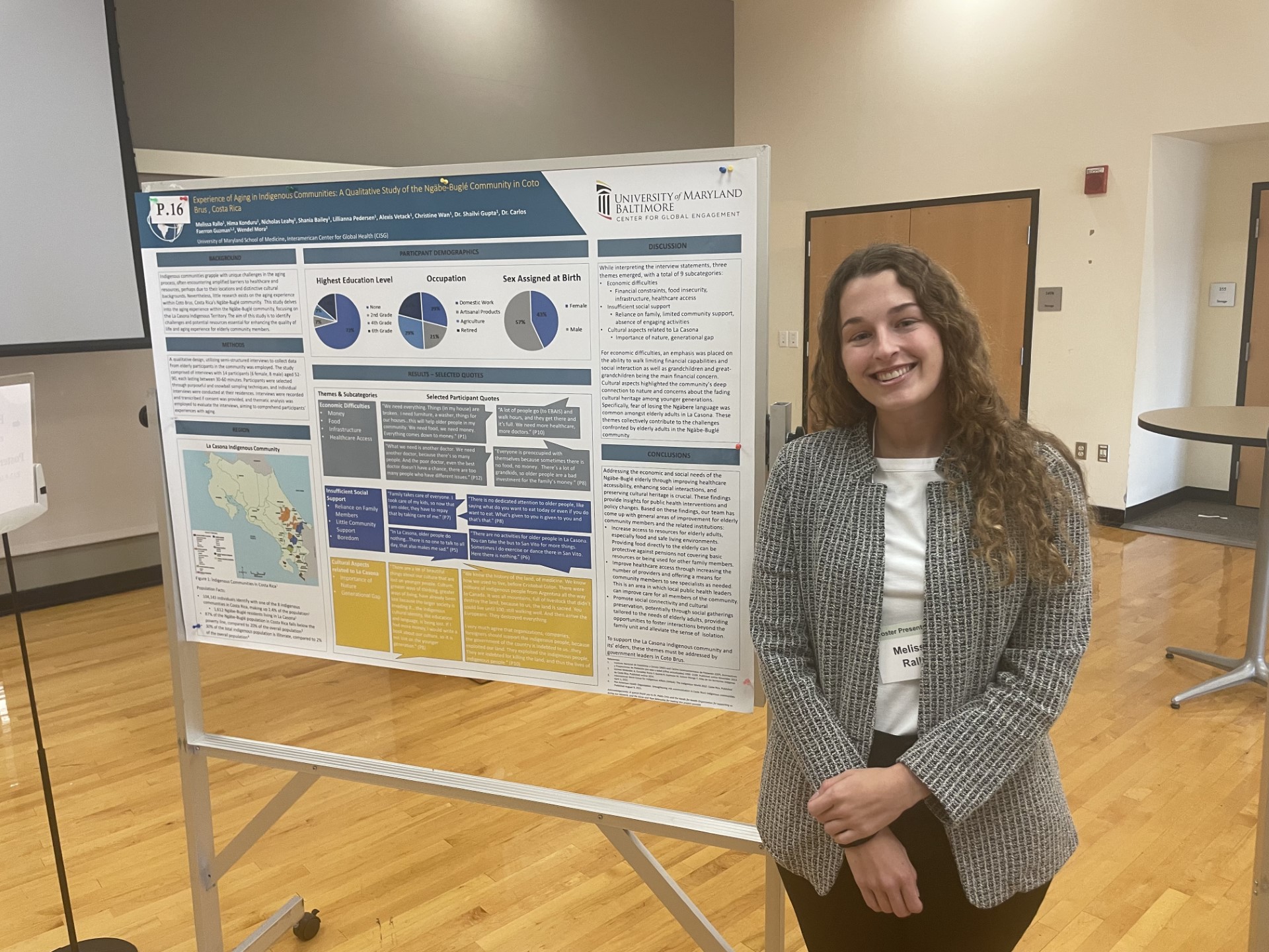 A student stands beside her poster.