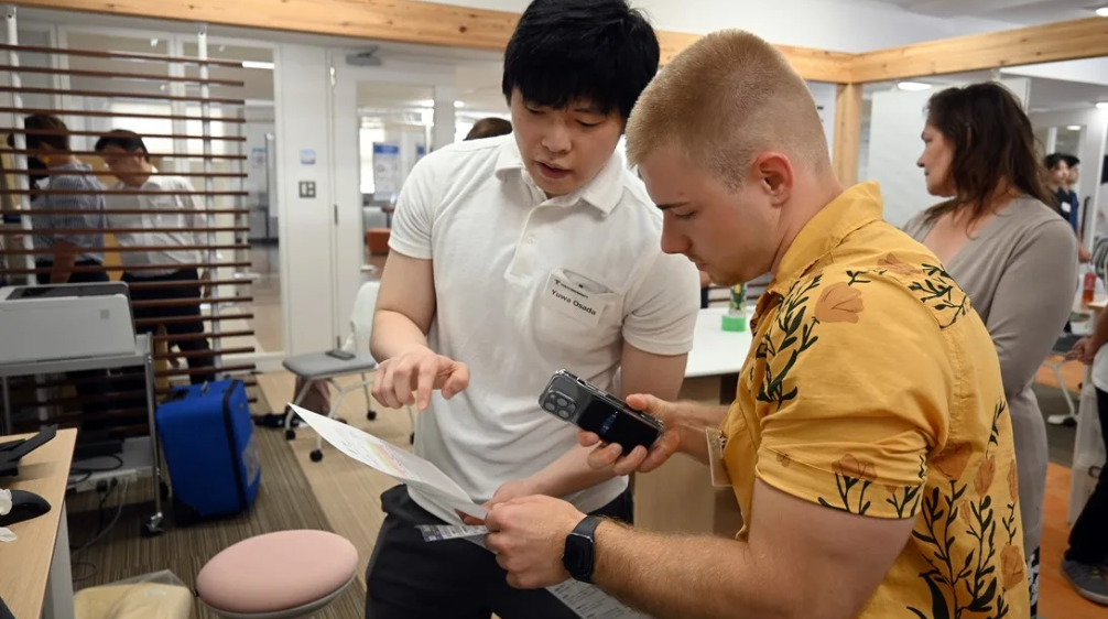 Two students examine medical equipment