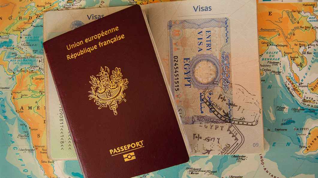 Two passports and drivers license on map