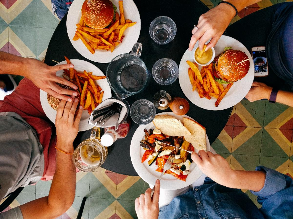 Above shot of hands with food on plates