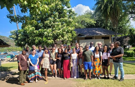 Students and faculty pose for a photo outside in Malawi