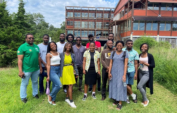 Malawi students and faculty pose for a photo outside a building