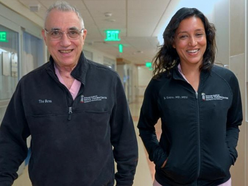 Dr. Thomas Scalea and Dr. Shailvi Gupta walk in the hallway of the UMMC Shock Trauma Center