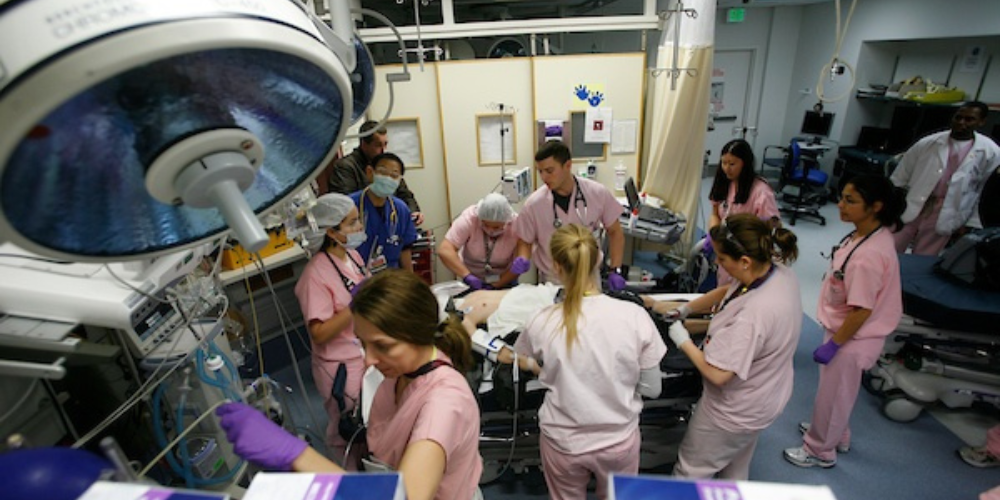 Trauma professionals conduct a simulation exercise in a trauma room.