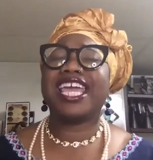 Black woman in African clothing sings