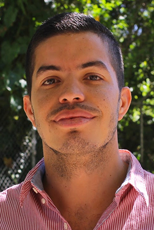 Headshot of man with trees behind him