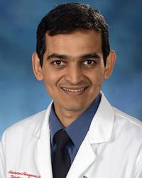 Headshot of Dr. Shivakumar Narayanan wearing a white medical jacket