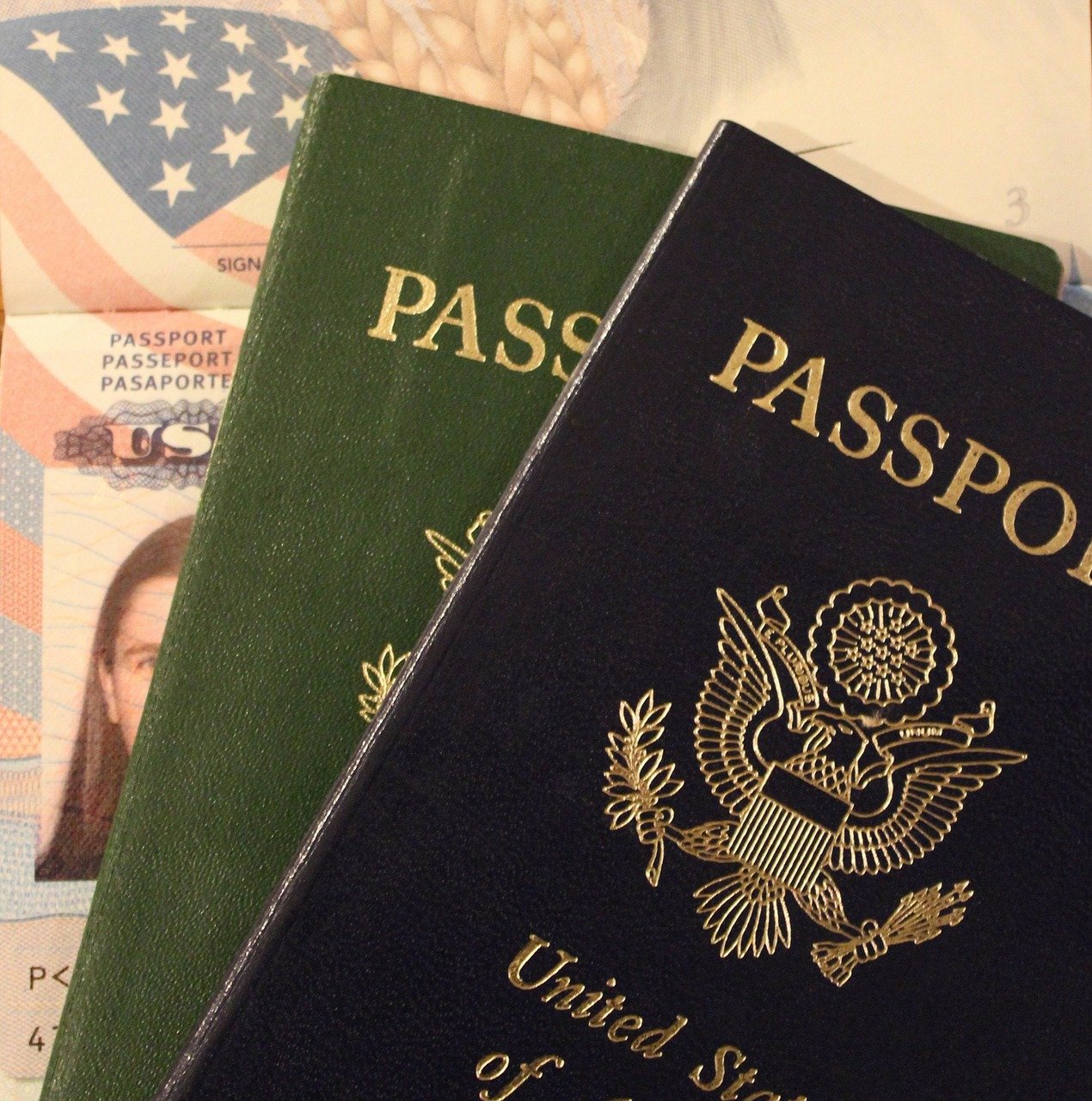 Two passports sit on top of an open passport