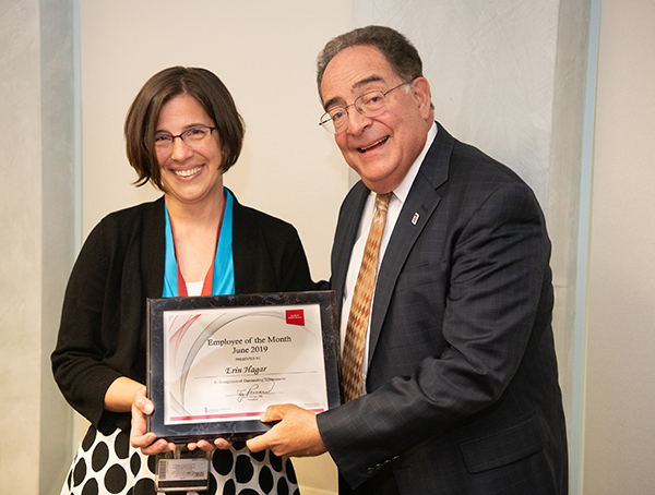 Erin Hagar receiving a certificate form the university's president