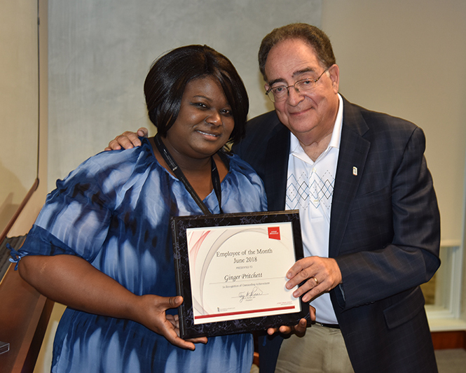 Employee of the Month Ginger Pritchett recieving her certificate from UMB's president