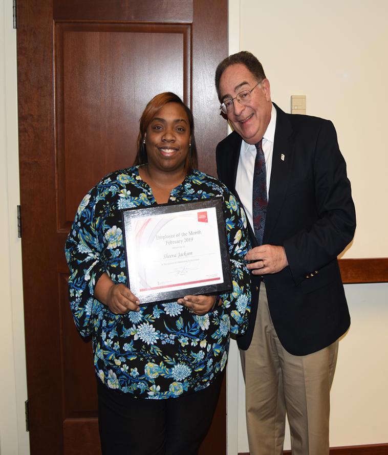 UMB's February 2019 Employee of the Month, Sheena Jackson, poses with University President Jay Perman.