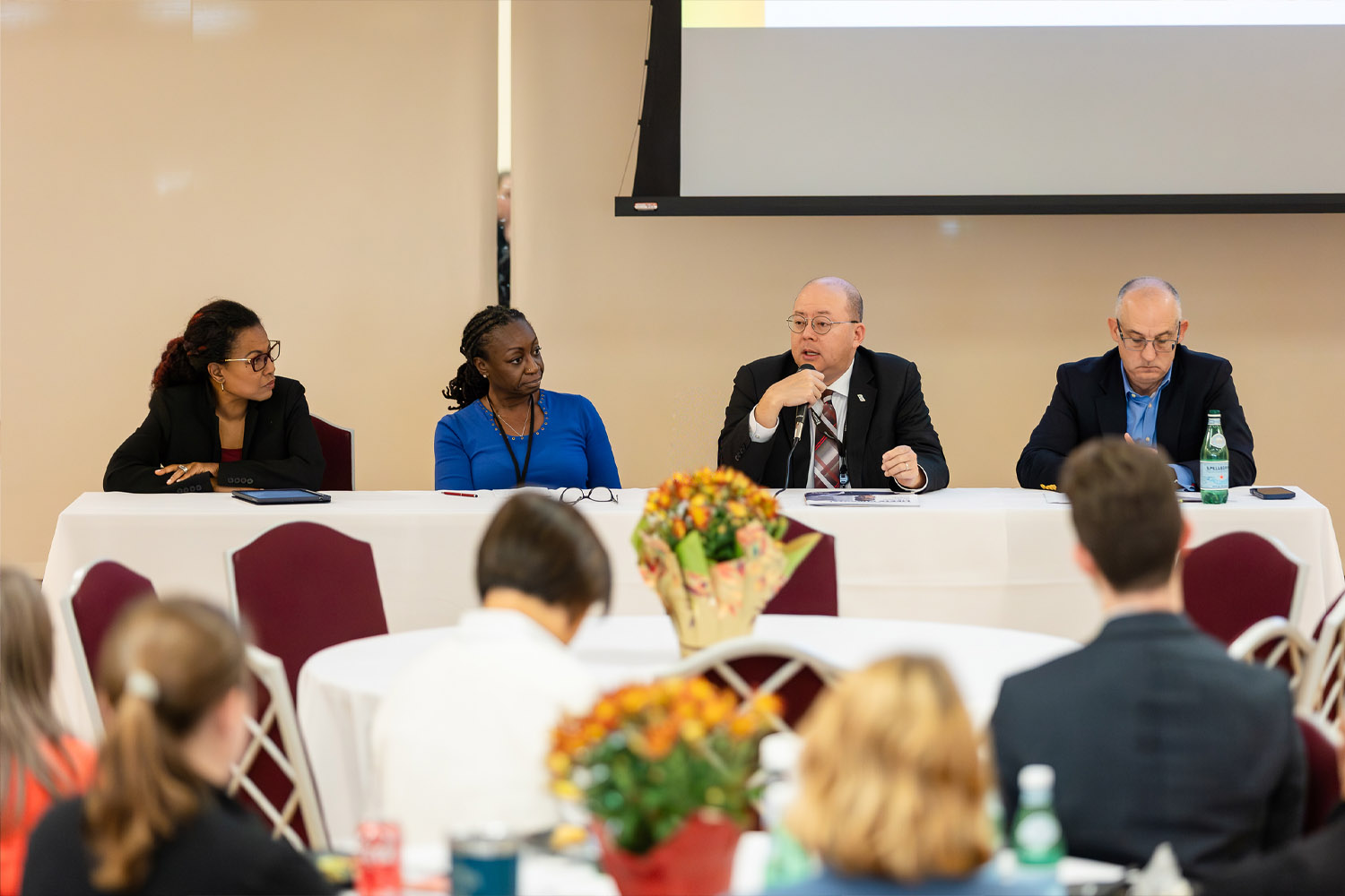 experts at head table speak to conference goers