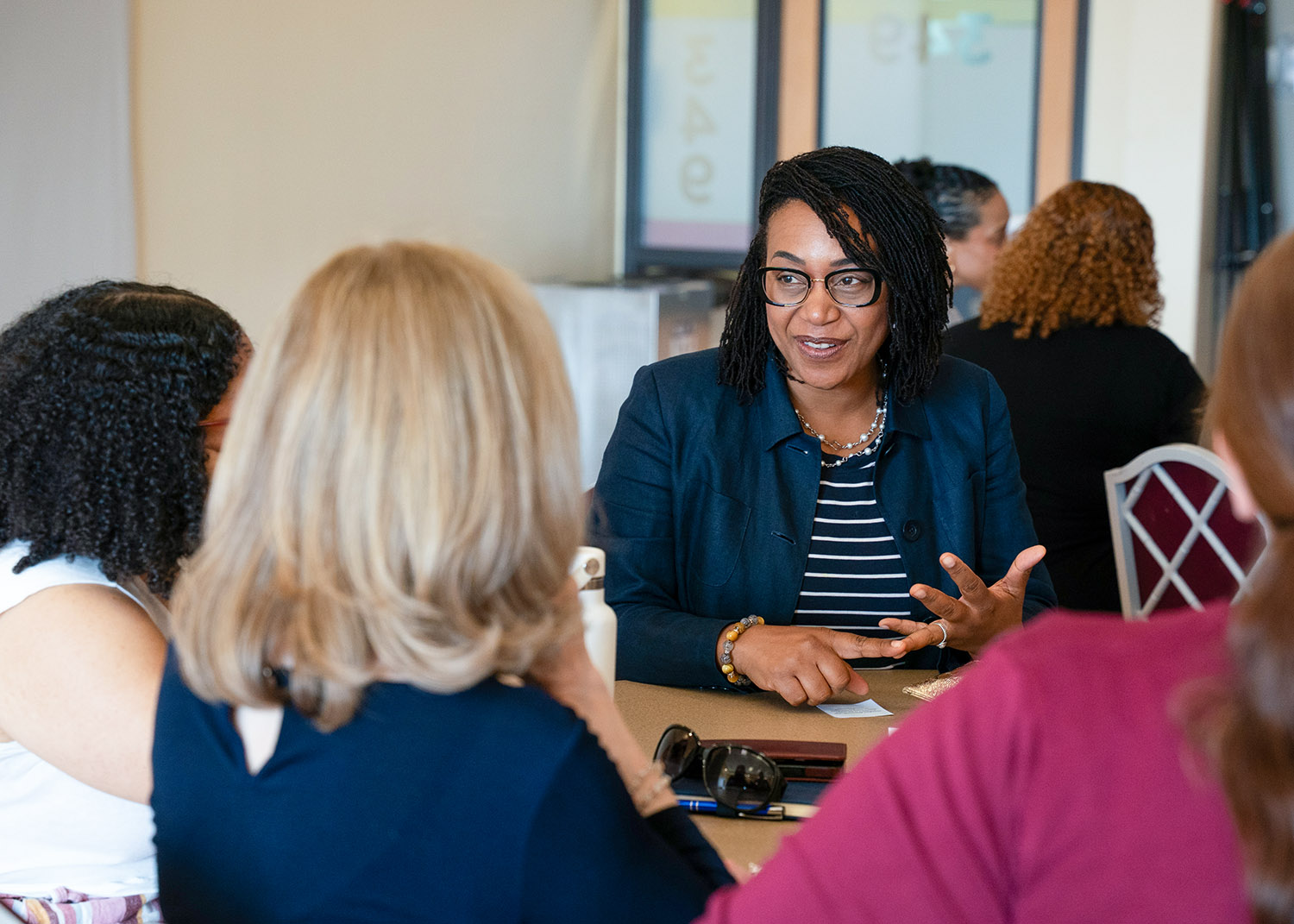 professional women talk around a table