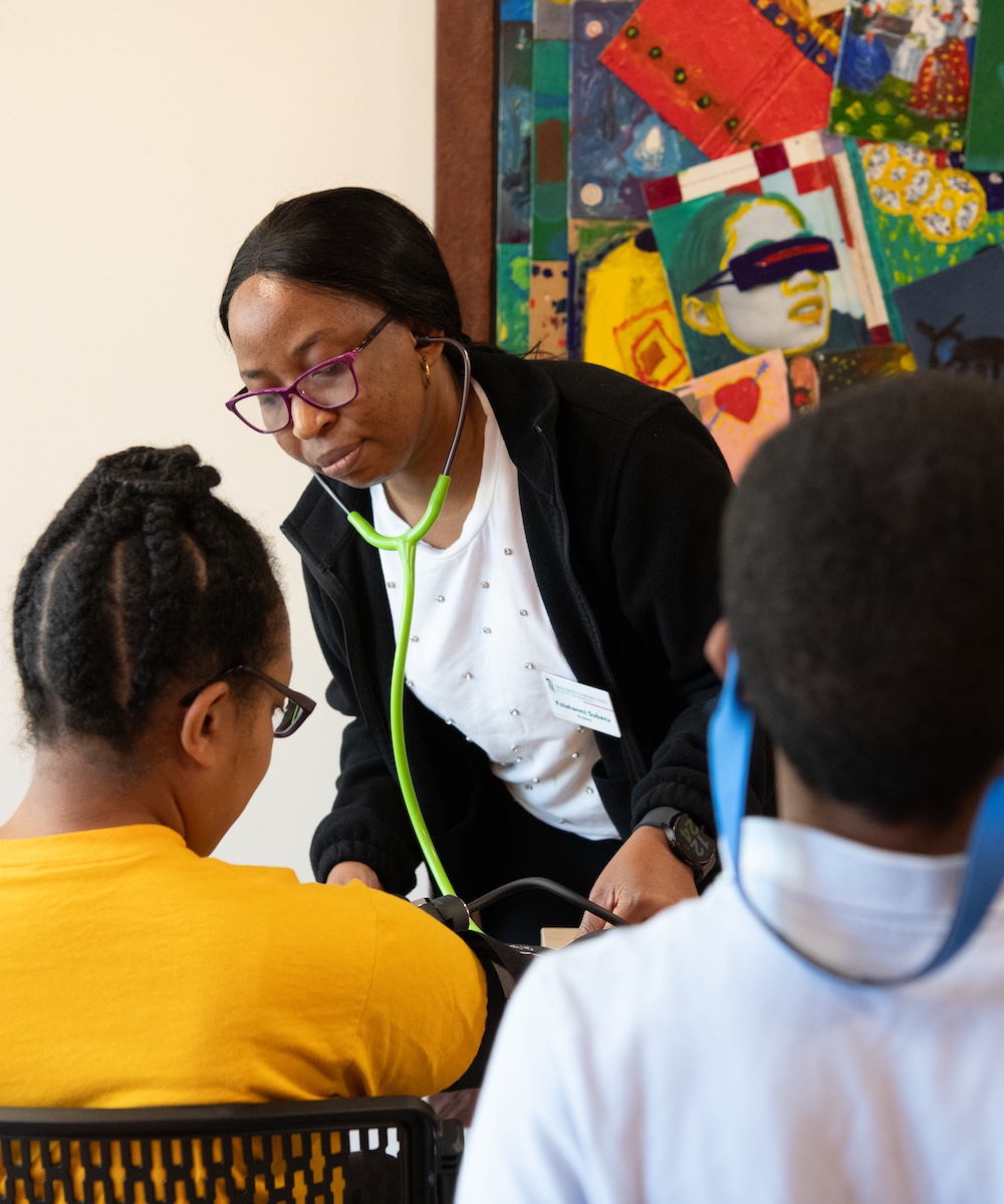 the University of Maryland School of Nursing conducts a health screening for a community member at a Prince George’s County Memorial Library branch.