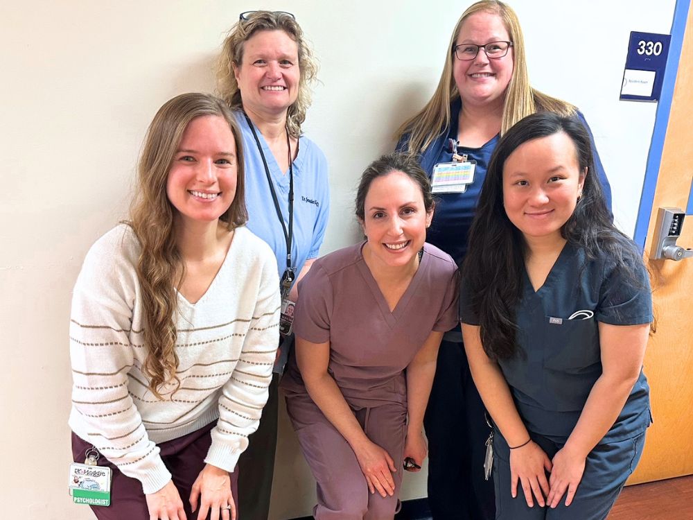 Erica Caffrey, DDS (center) and pediatric resident Gabrielle Le, DDS,  (right front) with the interdisclipinary team at Kenndedy Krieger.