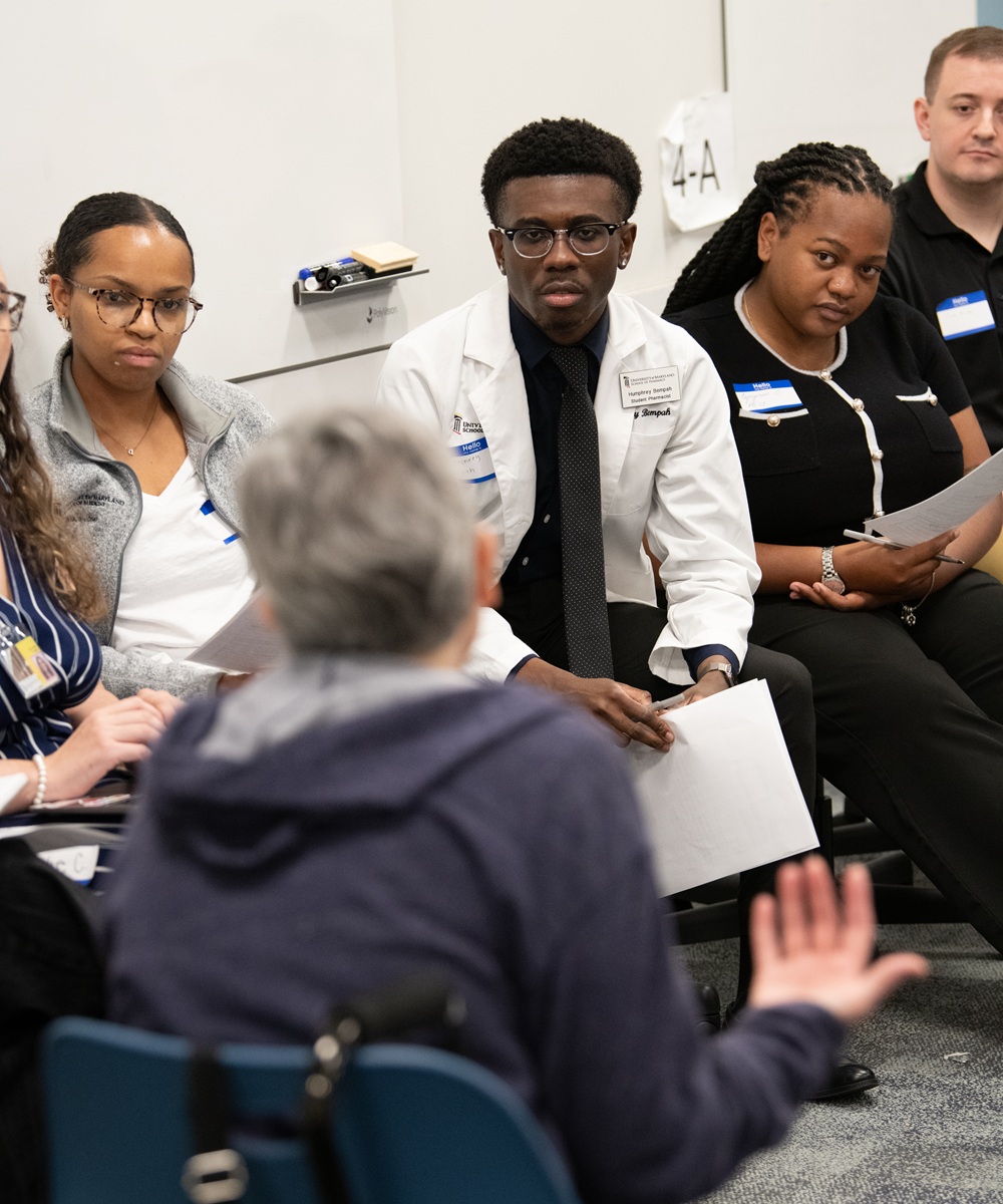 Students from schools across UMB's campus interview a breakout simulation session.