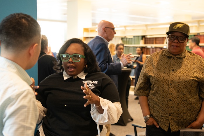 Jade Nesbitt discusses her venture, BACE, with attendees during the networking session following Grid Pitch 2026.