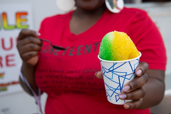An attendee enjoys a snow cone during UMB's fifth annual Juneteenth Jubilee on June 18.