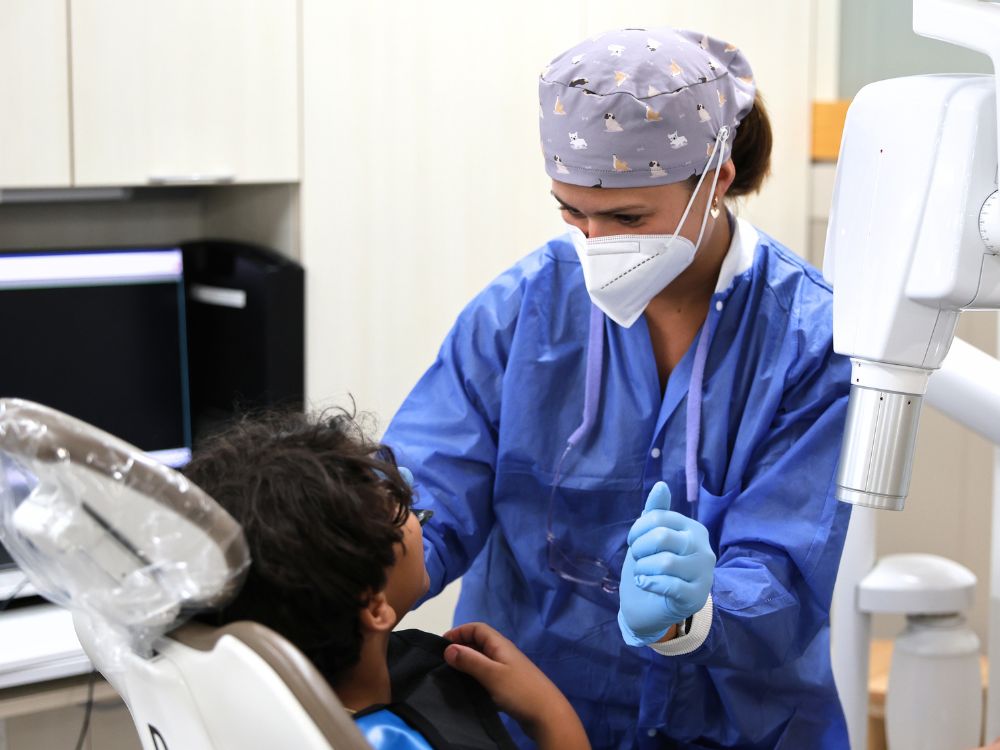 A dental student prepares a pediatric patient for an x-ray