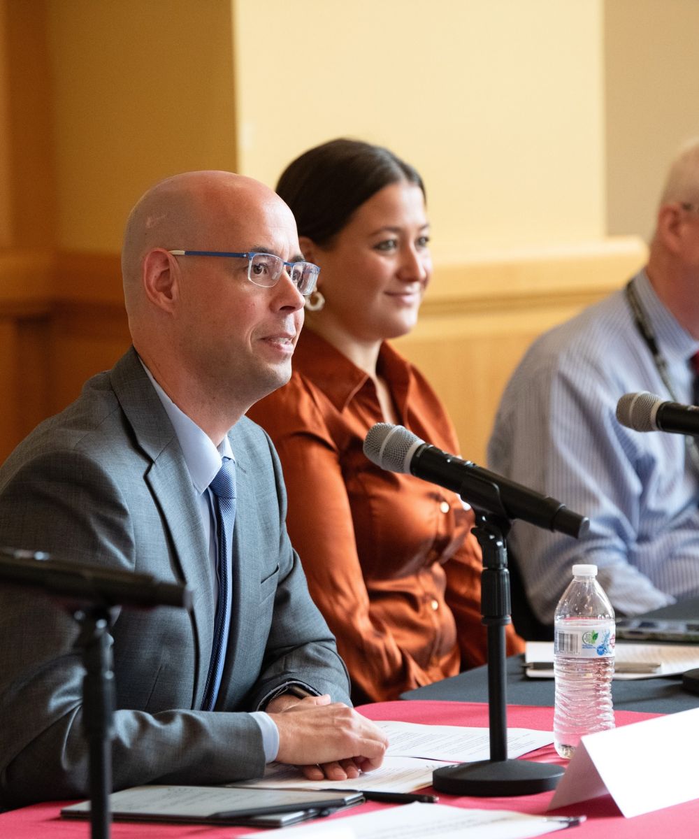Markus Rauschecker, JD, (left) chairs a meeting of the Maryland Cybersecurity Council held at UMB.