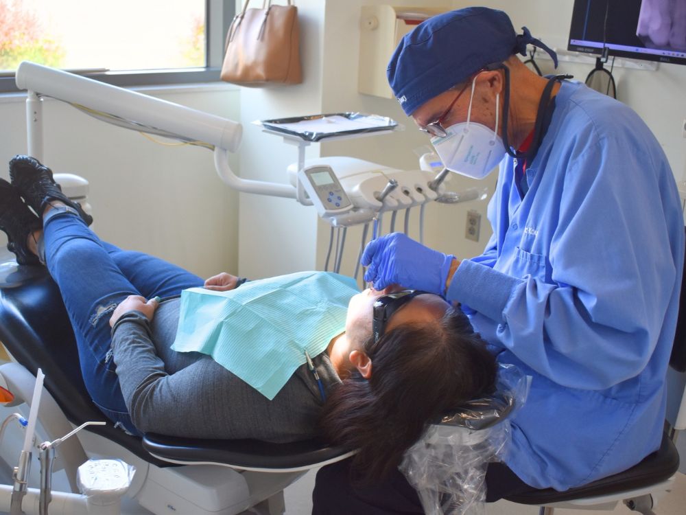 Dr. Ramsay Koury treats patient Bianca Rivas at the fall Mission of Mercy clinic held at Shady Grove.