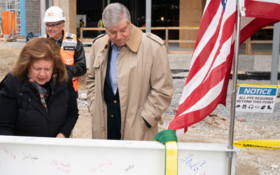 Jane Shaab signs the ceremonial steel beam at the 4MLK topping-off ceremony in West Baltimore.