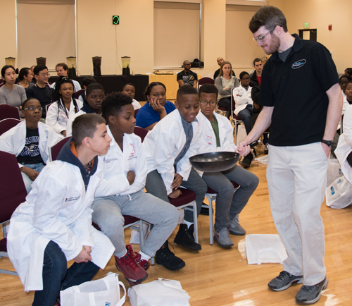 Sixth-graders in the UMB CURE Scholars program check out how quickly liquid nitrogen evaporates at a Maryland STEM Festival event put on at the University by the Maryland Science Center. 