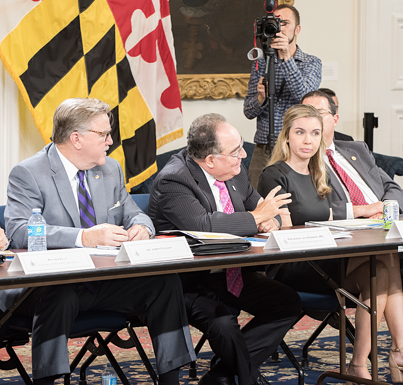 UMB President Jay A. Perman, MD, explains P-TECH's impact on West Baltimore youth, flanked by Maryland Higher Education Commission Secretary James Fielder and the governor's deputy legislative aide, Alexandra Keane.