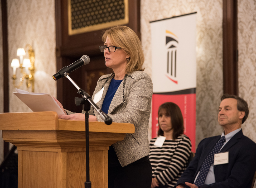 Michelle Tuten, PhD, MSW, associate professor at the University of Maryland School of Social Work, urges an end to stigma related to opioid-use disorder during a presentation that included Bethany DiPaula, PharmD, professor at the UM School of Pharmacy, and Eric Weintraub, MD, associate professor at the UM School of Medicine.