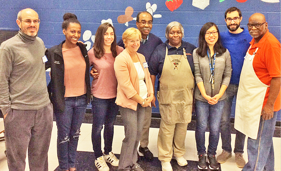 UMSOM Dean E. Albert Reece, MD, PhD, MBA, back row center; and Professors Sheri Slezak, MD, front center, and Anthony Harris, MD, far left; join Project Feast organizers Netsanet Woldegerima and Natalia Perez, second and third from left, and Alexander Thomopulos and Victoria Chen, second and third from right; and co-chefs Sheila Travers, fourth from right, and Clinton Tates, right.