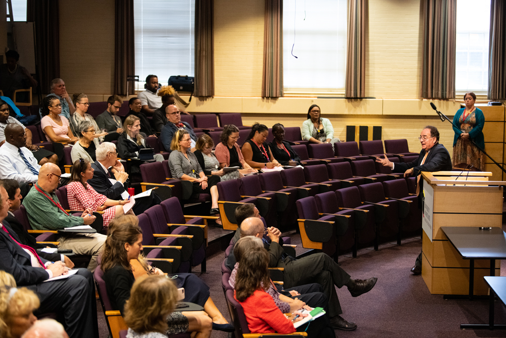 President Perman addresses audience at the School of Social Work auditorium.