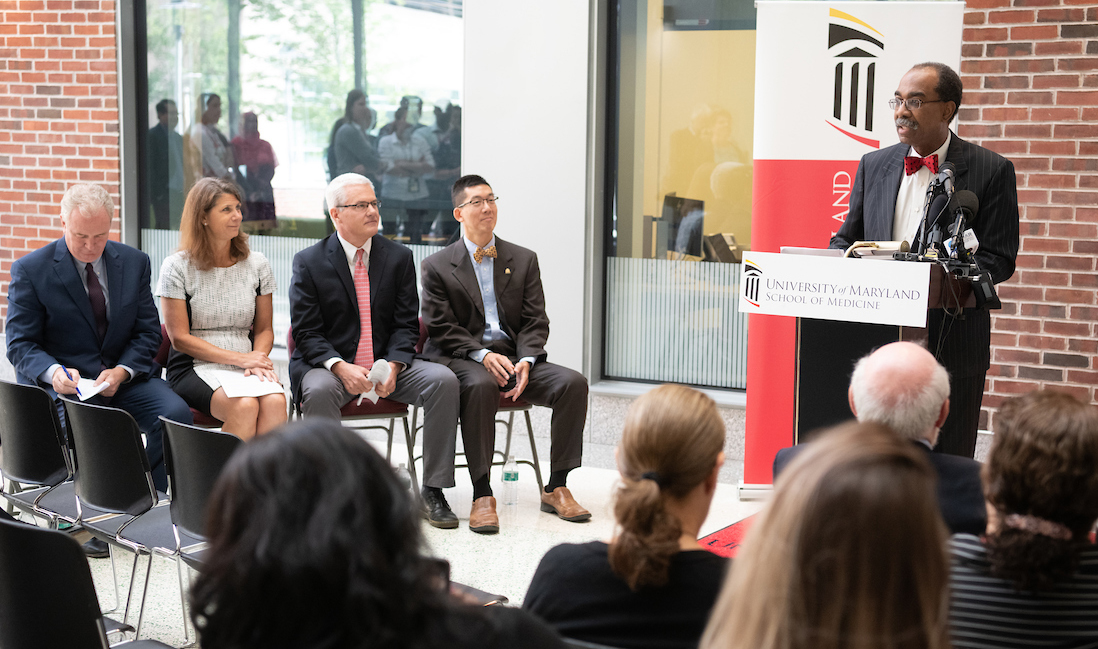 UMSOM Dean E. Albert Reece speaks as (l-r) Sen. Chris Van Hollen, Kathleen Neuzil, James Campbell, and Wilbur Chen listen.