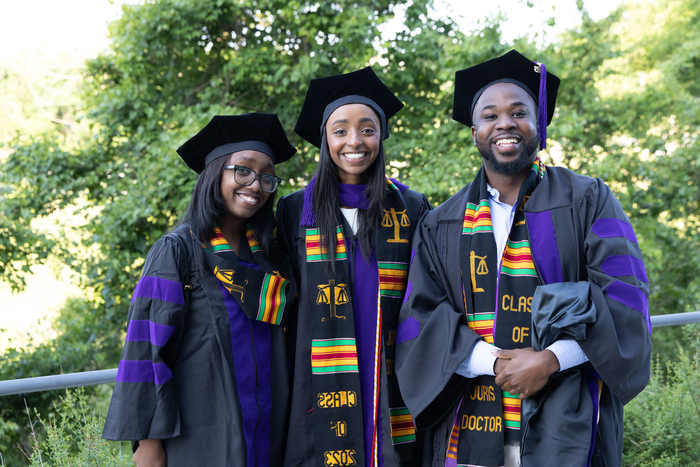 Fasika Delessa (center) with two fellow Francis King Carey School of Law graduates